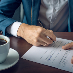 man writing something on a piece of paper