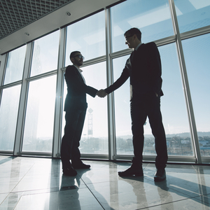 man shaking a hand of another man