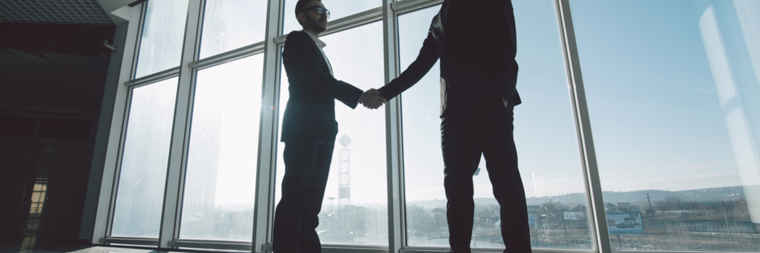 man shaking a hand of another man